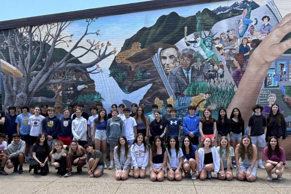 Double take: 23 sets of twins graduate from a single Massachusetts middle school